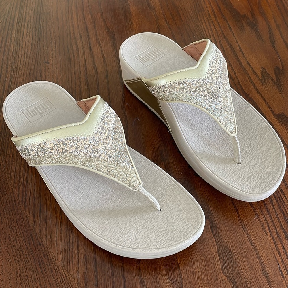 These beautiful gold flip-flops have only been worn one time.